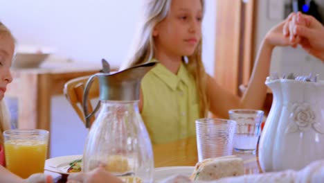 family praying together before having breakfast in kitchen 4k