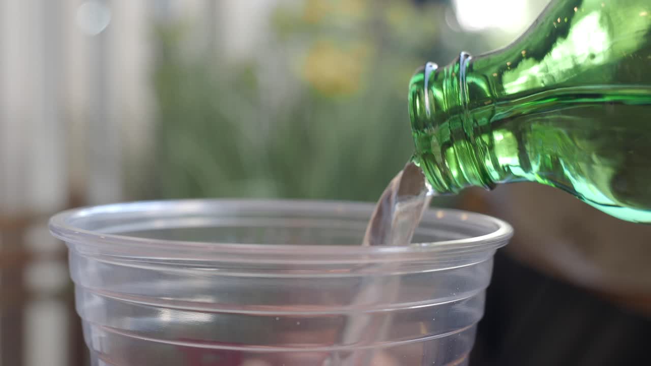 Pouring Soda into a Plastic Cup