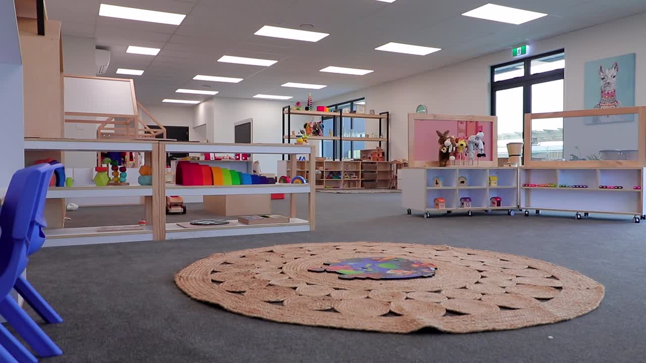 Jib down shot of a modern Playcentre room full of activities for kids in New Zealand