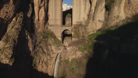 moving closer to the waterfall and arch at puente nuevo bridge, ronda, spain