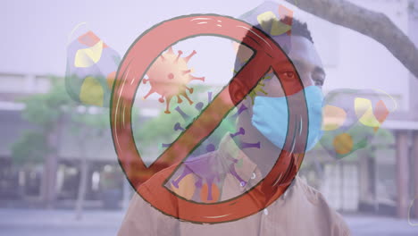 signo de parada sobre células de covid-19 y múltiples máscaras faciales contra el hombre afroamericano que usa una máscara facial