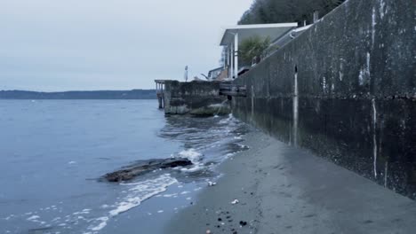 small lapping waves on sunrise beach in gig harbor washington with overcast gray skies
