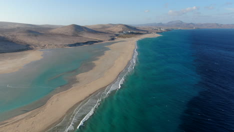 la barca beach, fuerteventura: aerial view traveling out over the shoreline of the beach and the turquoise waters