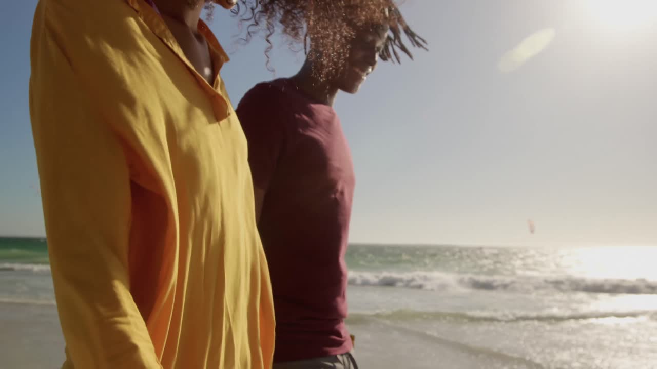 Couple walking together on the beach 4k