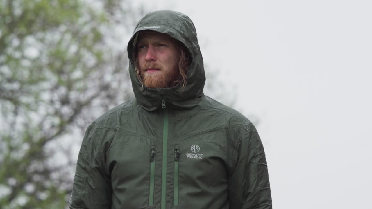 Front Portrait Of A Bearded Man Wearing Hooded Jacket Outdoor