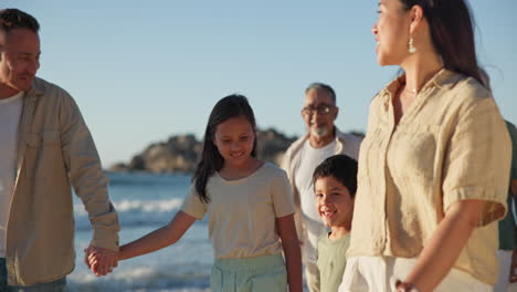 Beach,-walking-and-parents-holding-hands-with-kids