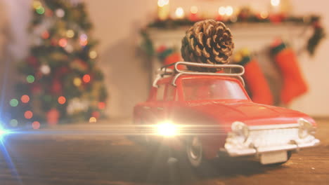 composition of light over christmas decorations with car and pine cone