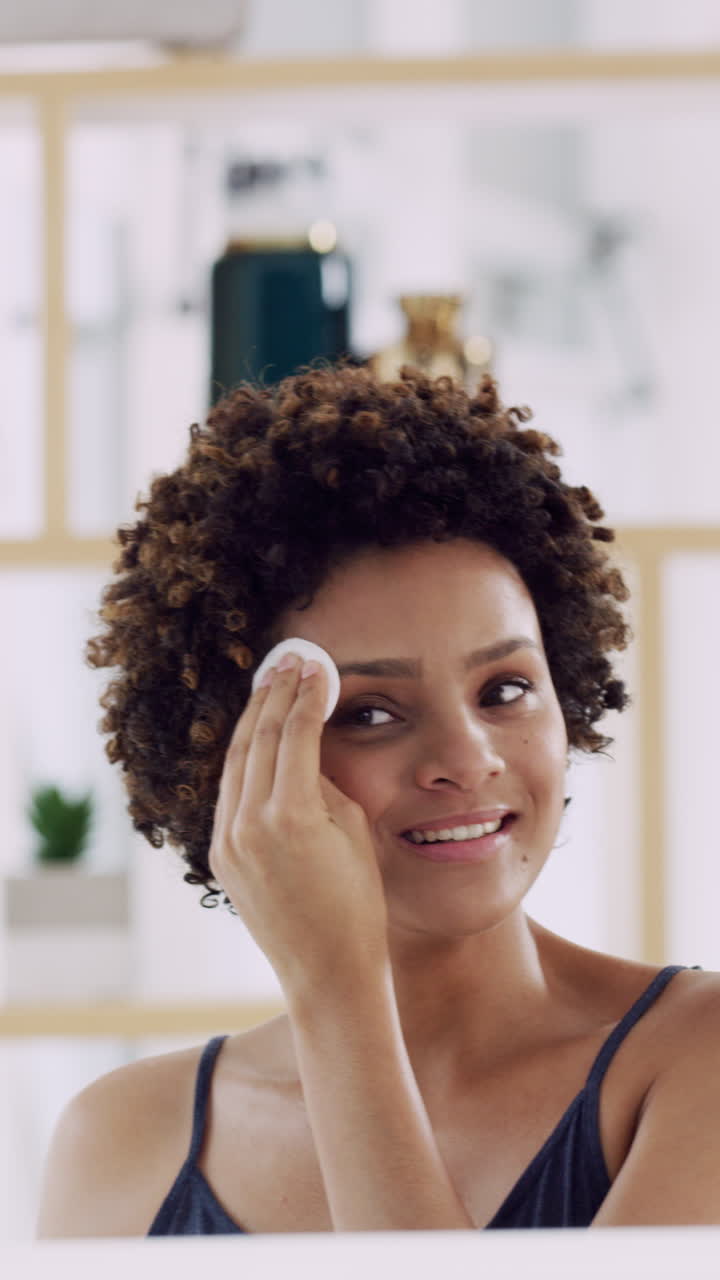Happy Young Woman Applying Skincare with Cotton Pad