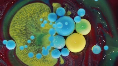 colorful bubbles. abstract yellow, red, blue, green mixture on a black background. artistic color paint background.