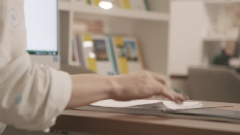 person working at a desk taking notes