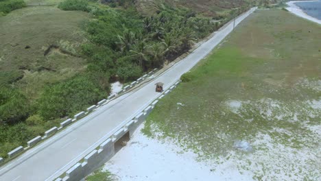 A-drone-spotlight-shot-of-a-tricycle-in-Sabtang,-Batanes