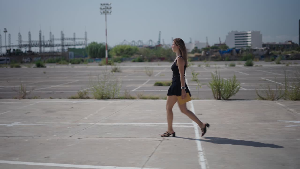 Woman Walking in Urban Parking Lot