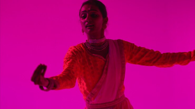 Waist Up Studio Shot Of Female Kathak Dancer Performing Dance Wearing Traditional Indian Dress Against Purple Background 2