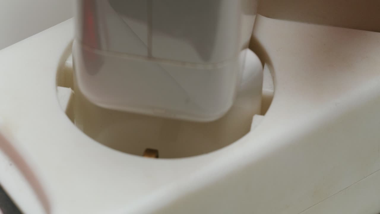 Close-up of a plug in a wall outlet