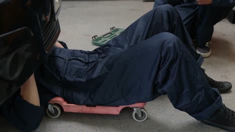 handsome mechanics repairing a car