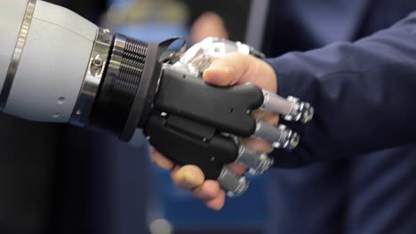 hand of a businessman shaking hands with a android robot.