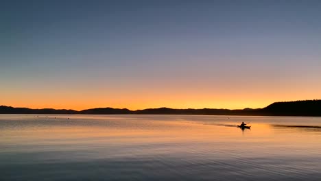 a single person kayak on a dreamy twilight lake landscape