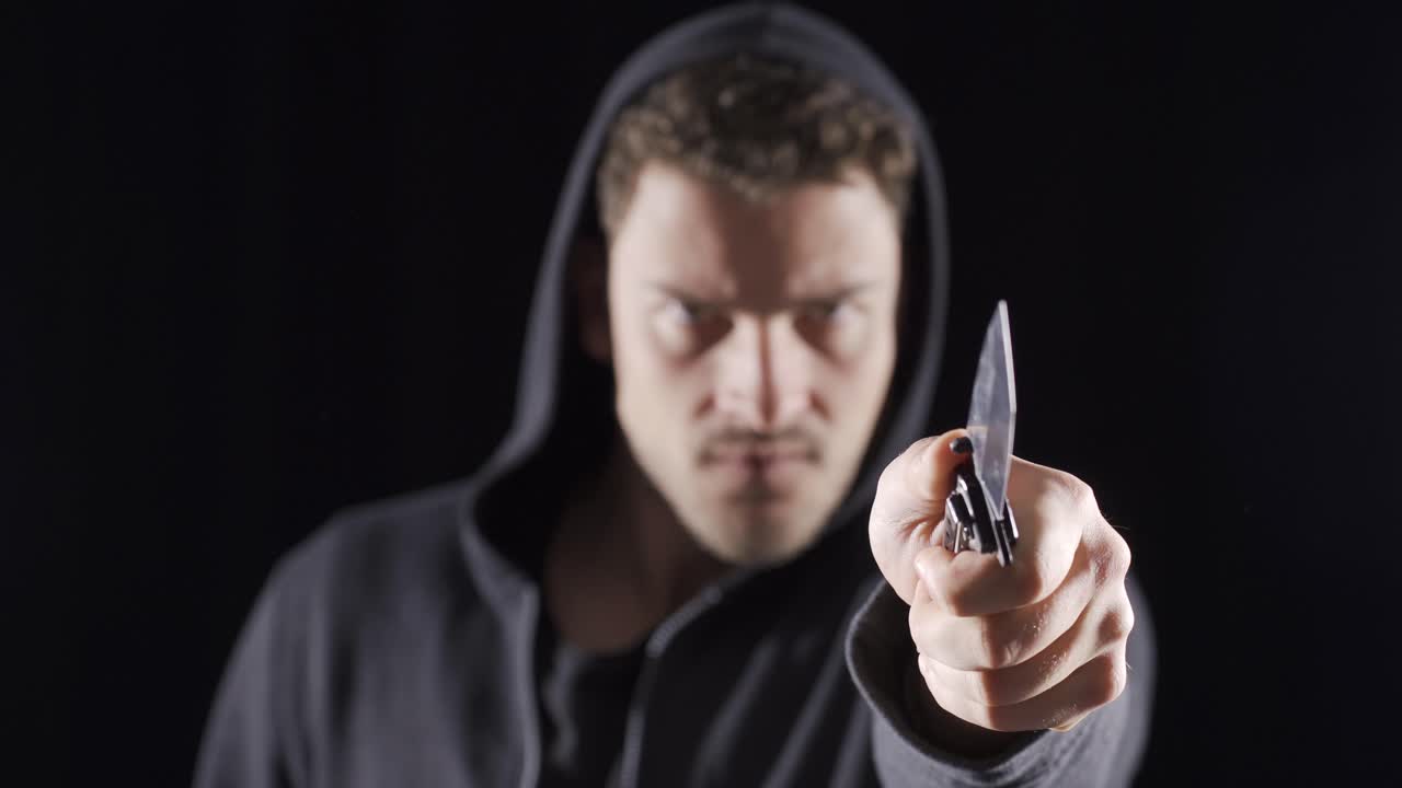 el hombre agresivo está haciendo movimientos con un cuchillo.