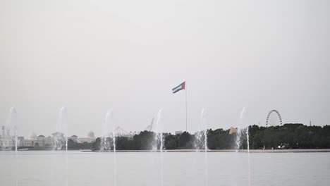 a wide view of the uae flag waving in the emirate of sharjah.