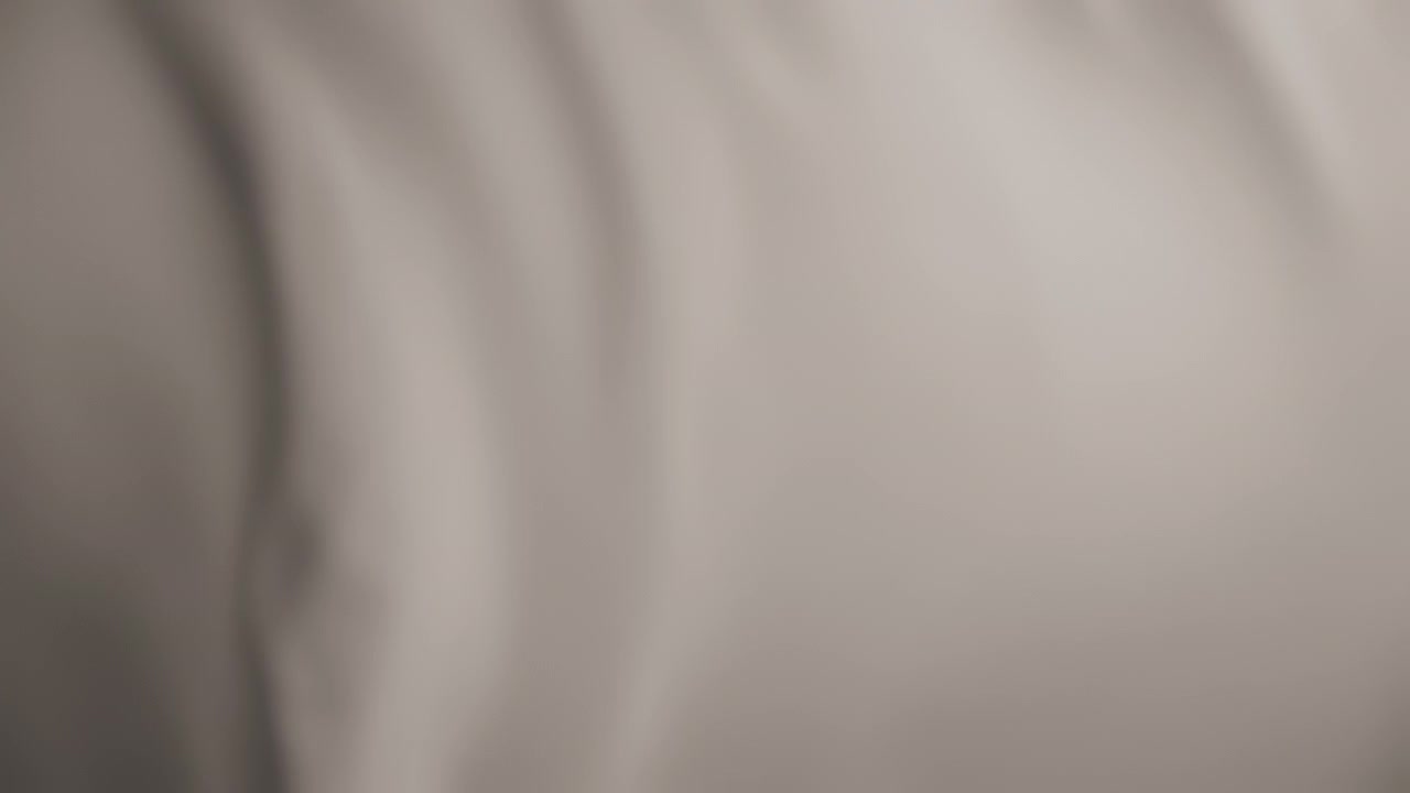 Silky pastel light brown fabric waving in the wind