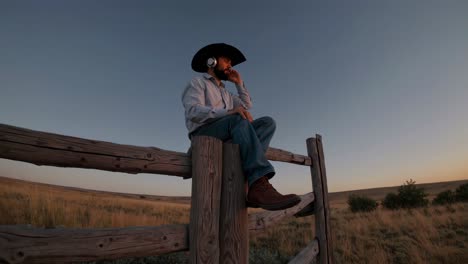 cowboy listening to music at sunset