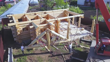 log cabin construction with crane