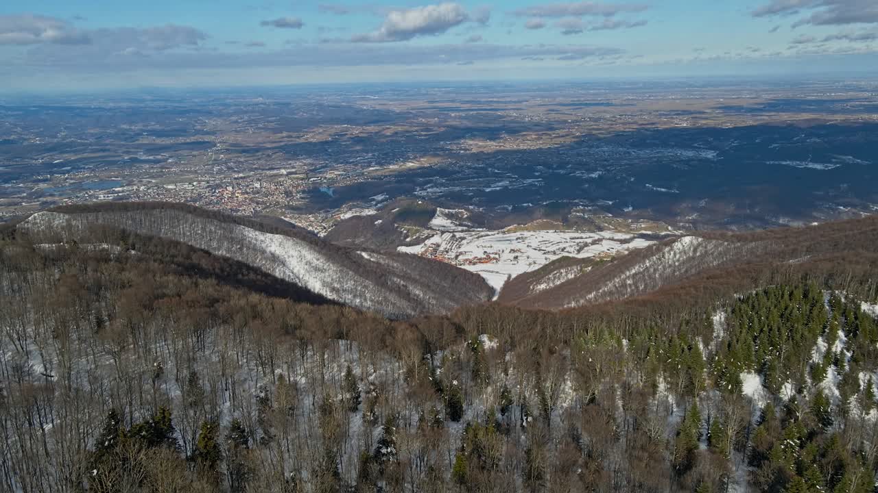 Aerial 4K drone footage of a mountain Ivan&scaron;čica and the snowy forest in the winter time