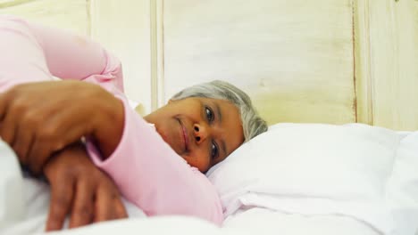 Granddaughter-comforting-sick-grandmother-in-bed-room-4k