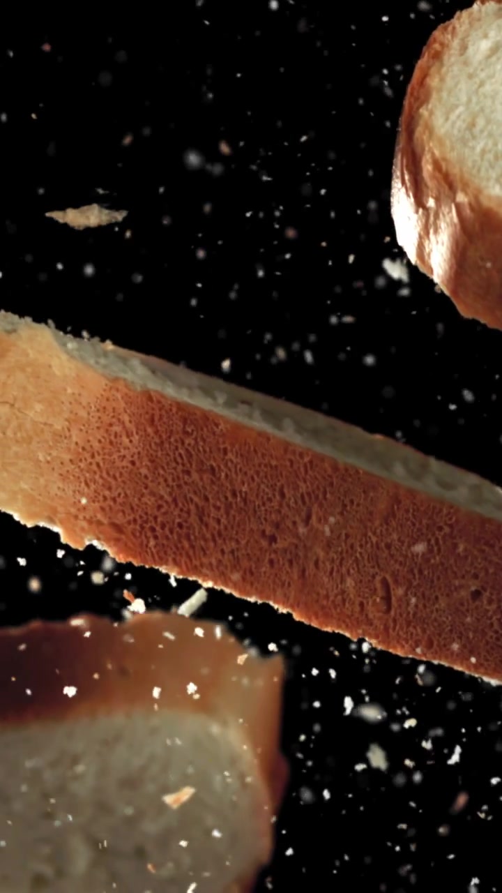 Fresh Bread Slices and Crumbs Falling in Slow Motion