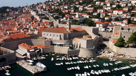 aerial view of boats at old port with old town and dominican convent in croatia