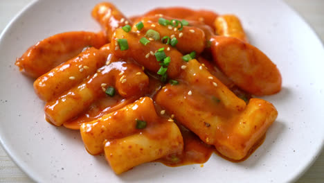 korean rice cake stick with sausage in spicy sauce - tteokbokki