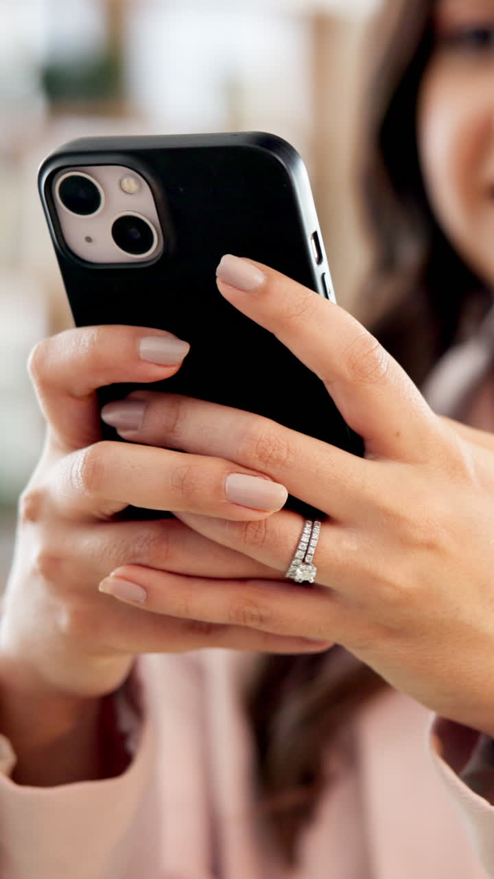Close-up of Woman's Hands Holding Smartphone with Engagement Ring