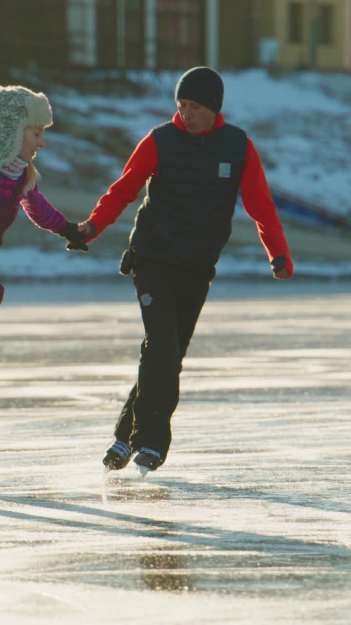 A Joyful Winter Scene of Two Ice Skaters Gliding on a Frozen Lake, Embodying the Spirit of Fun and Adventure Amidst Nature's Serene Beauty and the Chill of a Cold Day