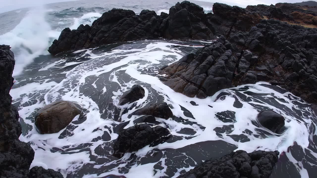 Waves Crashing on Black Volcanic Rocks