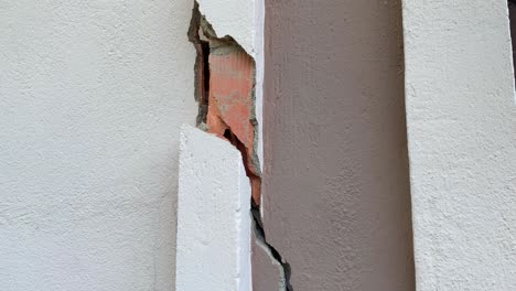 big crack on a wall in an old building, 4k tilting up