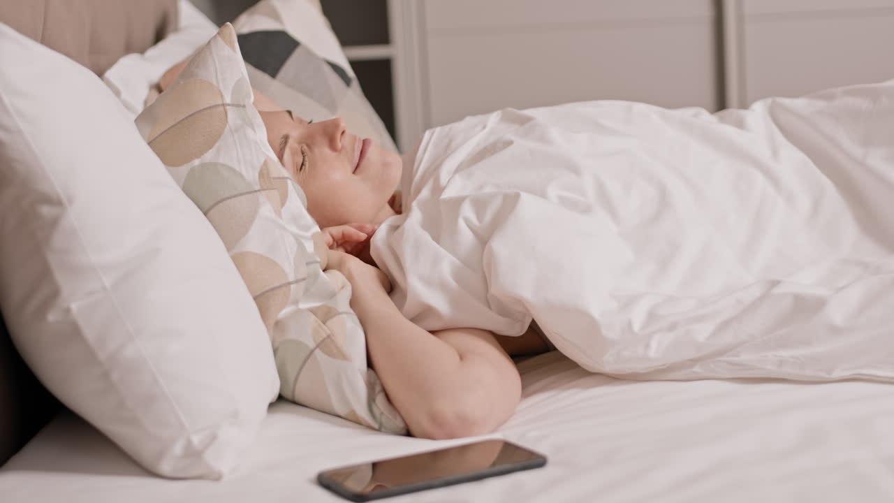 Smartphone Alarm Waking up Happy Woman