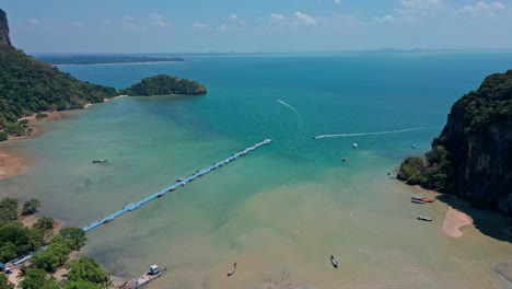 the floating pier on railay bay beach in krabi, thailand - aerial drone shot