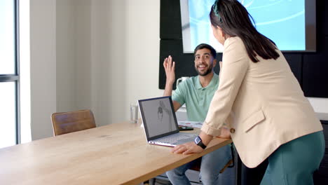discussing project, colleagues using laptop with robotic design in modern office, copy space