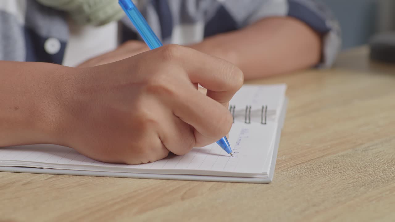 niño escribiendo en un cuaderno