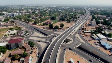 highway crossroad and interchange at yola town, nigeria - pull back aerial reveal
