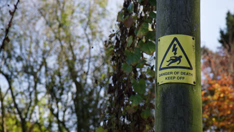 a danger of death keep out sign on the post in city park near okehampton, devon, uk. close-up shot
