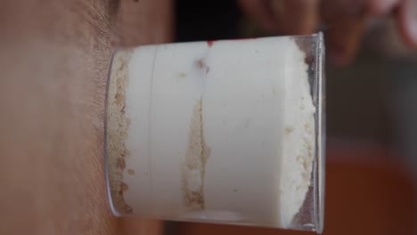 layered creamy dessert in glass cup