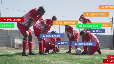 Social-media-concept-icons-against-team-of-diverse-tired-male-soccer-players-on-sports-field