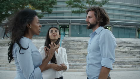 employee explaining something to her colleagues at the street