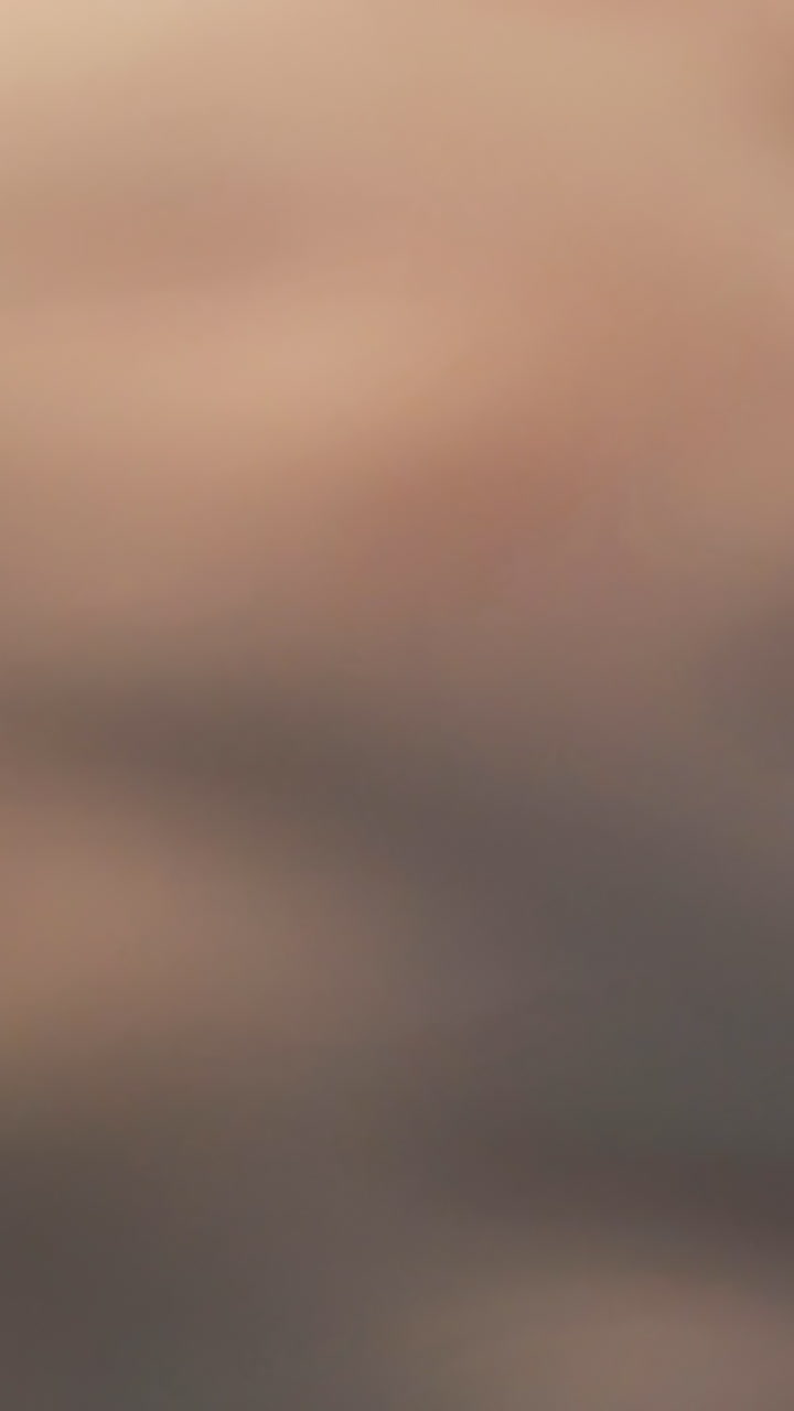 CU: Professional tailor cuts black leather belt edges with metal corner cutter on green cutting board extreme closeup