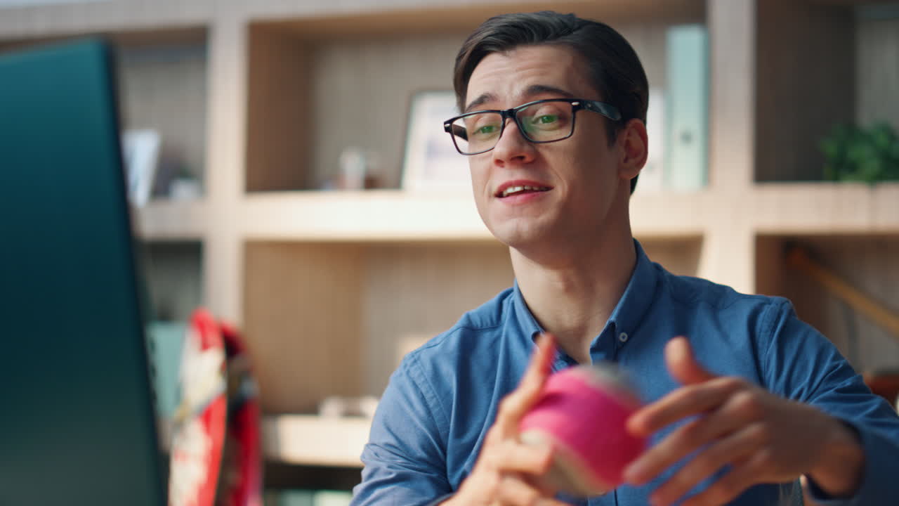 Nærbillede af positiv freelancer der taler på computer videoopkald på kontoret. Mand gestikulerer.