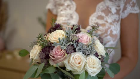 beautiful bride in wedding dress holding rose flowers bouquet, orbiting shot