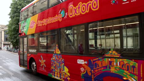 electric tour bus passing historic oxford buildings