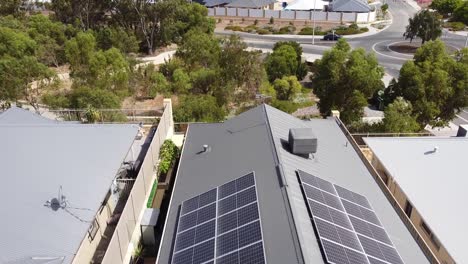 solar panels on the roof of building with vehicles, trees in background