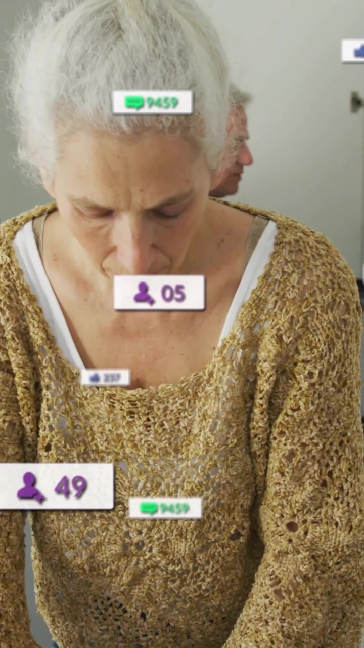 Vertical video: Woman folding shirt for laundry while man sorting nearby causing counts to rise